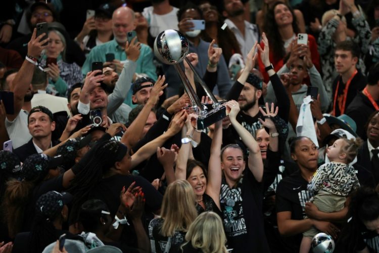 Sabrina Ionescu of the New York Liberty and club owner Clara Wu Tsai hoist the WNBA Championship Trophy after defeating the Minnesota Lynx in game five of the WNBA Finals. ©AFP