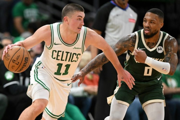 Payton Pritchard drives past Damian Lillard to help Boston defeat the Milwaukee Bucks in the NBA on Monday. ©AFP