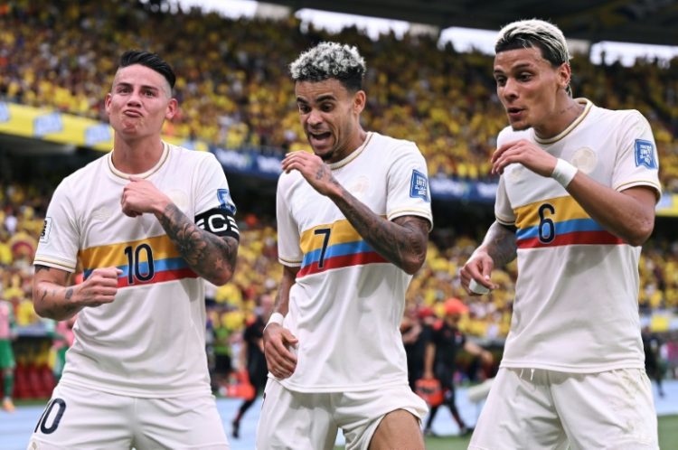 Colombia's forward Luis Diaz (7) celebrates with team-mates James Rodriguez (10) and Richard Ríos after scoring in Tuesday's CONMEBOL World Cup qualifier against Chile.. ©AFP