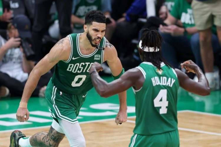 Jayson Tatum, left, and Jrue Holiday will try and spark the Boston Celtics to a second straight NBA title in the league's 79th campaign, which begins on Tuesday. ©AFP