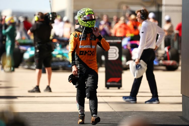 Rueful: Lando Norris of McLaren looks on in parc ferme . ©AFP