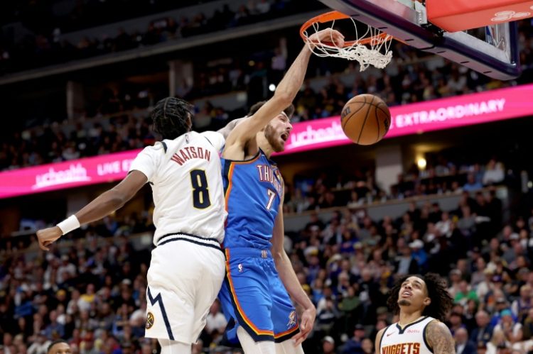 Oklahoma City's Chet Holmgren  dunks on Peyton Watson in the Thunder's NBA win over the Denver Nuggets. ©AFP