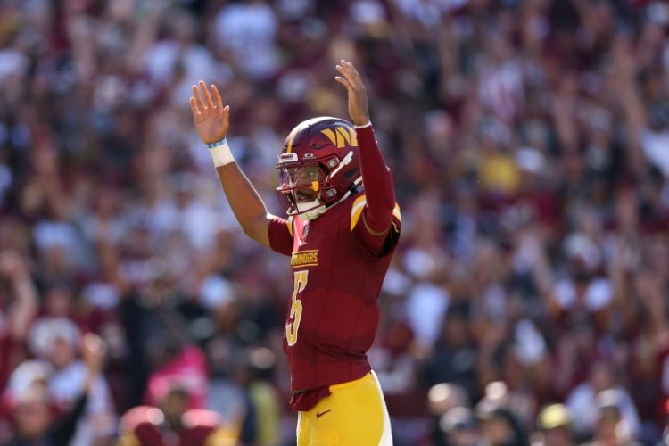 NFL rookie quarterback Jayden Daniels of the Washington Commanders, shown celebrating a touchdown, has the club off to a 4-1 start, its best since 2008. ©AFP