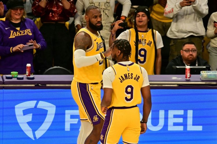 LeBron James and his son Bronny became the first father and son duo to play in the NBA as they featured for the Los Angeles Lakers against the Minnesota Timberwolves on Tuesday.. ©AFP