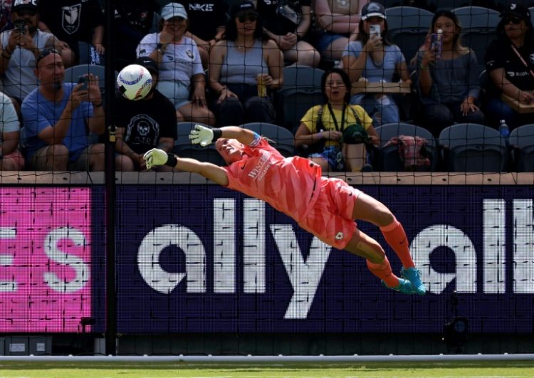 Alyssa Naeher, making a diving save in an NWSL contest, said she is retiring from international football after two final US women's national team matches in Europe. ©AFP