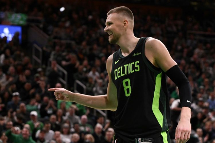 Kristaps Porzingis of the Boston Celtics celebrates after a basket in his return for the NBA champions after being out since June ankle surgery following an injury in last season's NBA Finals. ©AFP