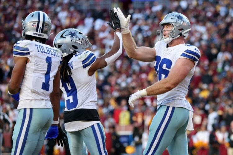 Luke Schoonmaker of the Dallas Cowboys celebrates a fourth-quarter touchdown catch as the visitors snapped a five-game NFL losing skid by beating the Washington Commanders. ©AFP