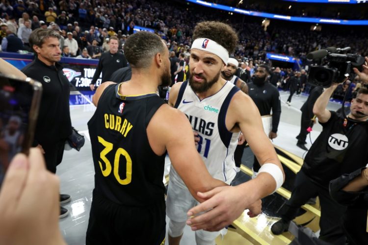 Dallas Mavericks star Klay Thompson (right) hugs former Golden State teammate in his first game back in San Francisco since his departure in July. ©AFP