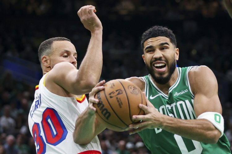 Boston's Jayson Tatum (right) battles with Golden State's Stephen Curry in a see-saw NBA clash on Wednesday . ©AFP