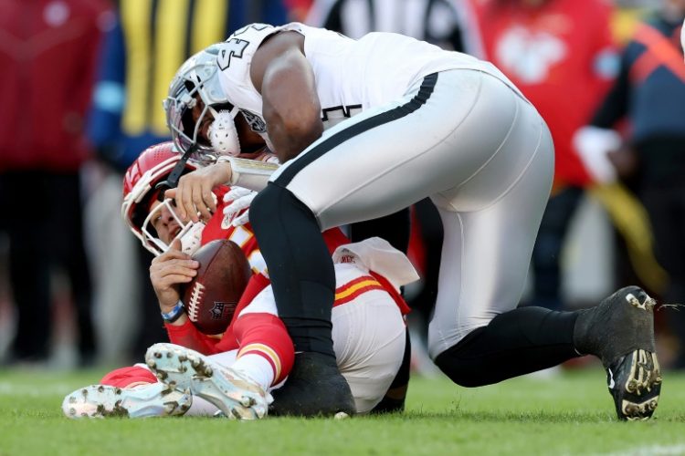 Kansas City quarterback Patrick Mahomes is sacked by K'Lavon Chaisson of the Las Vegas Raiders in the Chiefs' 19-17 NFL victory over the Raiders. ©AFP