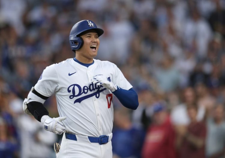 Shohei Ohtani of the Los Angeles Dodgers reacts after hitting a solo home run in a game against Baltimore in the 2024 Major League Baseball season. ©AFP