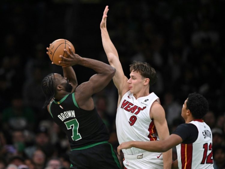 Jaylen Brown attempts to shoot over Pelle Larsson and Dru Smith during the Boston Celtics' rout of the Miami Heat on Monday. ©AFP