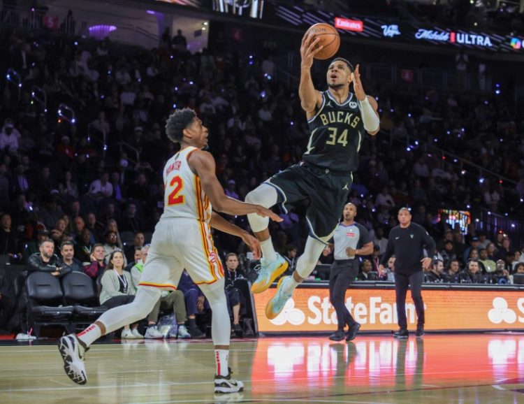 Milwaukee's Giannis Antetokounmpo scores a layup against Atlanta's Keaton Wallace, two of a team-high 32 points to spark the Bucks over the Hawks and into the NBA Cup final. ©AFP