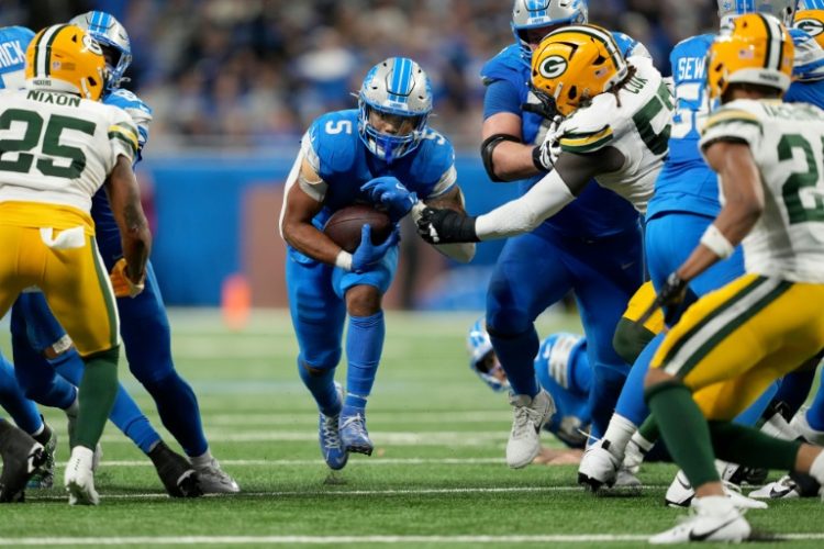 David Montgomery of the Detroit Lions runs for a first down in the Lions' NFL victory over the Green Bay Packers. ©AFP