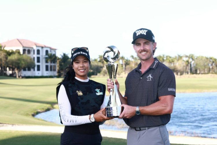 Patty Tavatanakit of Thailand and Jake Knapp of the United States pose with the trophy after winning the Grant Thornton Invitational pairs event featuring LPGA and PGA players. ©AFP