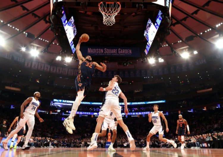 Karl-Anthony Towns of the New York Knicks soars for a dunk over Franz Wagner in the Knicks' NBA victory over the Orlando Magic. ©AFP